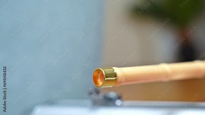 Shooting from pipe with dart with sleeping pills on tip of dart. Dart with sleeping pills on tip flies out of wooden tube due to jolt of air