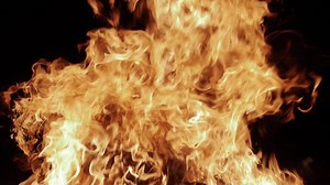 Fire engulfs a log in slow motion