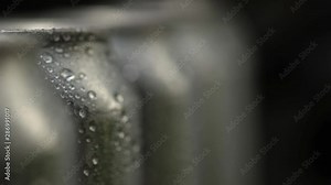 macro photography of wet aluminum cans with water drops that stand in a row. The focus moves from the background to the foreground. macro photography with Studio lighting.