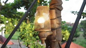 Garden bulb lamp with yellow light and woven bamboo