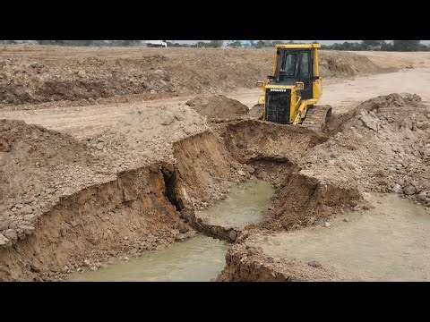Dozer Pushing Soil Bury Mud With 5T Dump Trucks On Big Land