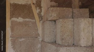 Hempcrete bricks and wall interior in a construction site, panning left to right