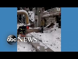 Ukrainian emergency workers clear rubble from airstrike