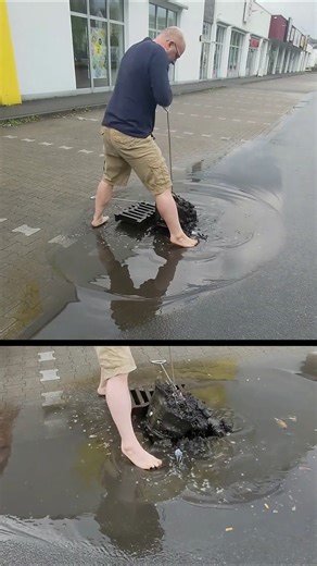 S#067-3 Unclogging a storm drain on a parking space after rain in Germany, #shorts
