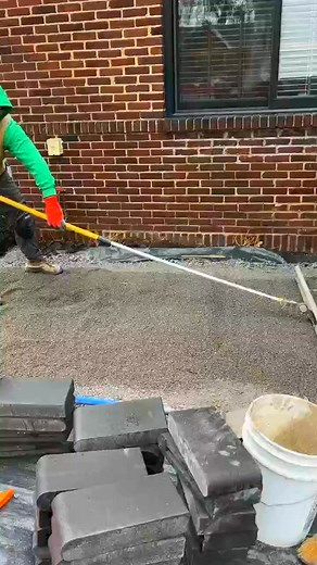 Screeding a bedding course of #9 limestone. #pavers | HD 1910