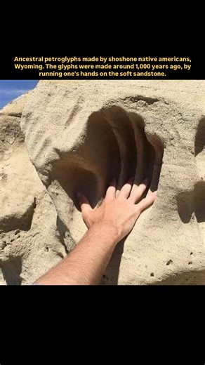 Memoir World on Instagram: "In the sandstone cliffs of Wyoming, ancestral petroglyphs created by the Shoshone Native Americans still remain, carved not with tools, but by the simple act of human touch. These markings—some over 1,000 years old, others as recent as 200 years ago—were made by rubbing hands against soft sandstone surfaces, slowly wearing down the rock over generations. The result is a collection of sacred symbols, paths, and impressions that speak to a deep and lasting connection to