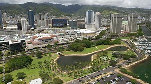 Cinematic panning 4K aerial drone shot of high-rise hotels on the shore of Ala Moana, vibrant, popular tourist destination near Honolulu on Oahu island in Hawaii known for its surfing and beaches