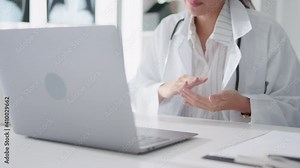 Asian female doctor using laptop computer online video call remote talking to patient, prescribe medicine. Tele medical, telehealth, hospital clinic health care service, or internet technology concept