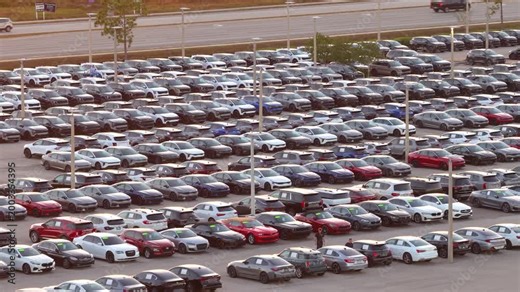 Automotive distribution center with cars lined up for sale and delivery, illustrating logistics, transportation networks and large-scale car inventory management.