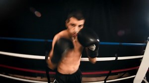 POV Go Pro footage of a boxer throwing punches at their competition in a boxing ring