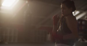 Sportswoman shadow boxing under sunlight