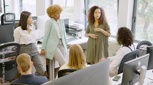 Woman scolding multi-ethnic colleagues in the office of a coworking