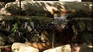 Stream with water flowing in a public park on Ischia. The island is rich in thermal waters and there are numerous pools and thermal water parks.