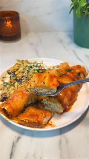 Made With Mel on Instagram: "These high-protein chicken enchiladas are easy to make and delicious!! The perfect 30 minute weeknight meal! 🧡🙌🏼 Ingredients ⭐️ 1/2 cup refried beans 3/4 cup Greek yogurt 1 Tosp taco seasoning 3 cups shredded chicken (I used a rotisserie chicken) 1.5 cups shredded Mexican cheese 10 oz. can red enchilada sauce 8 flour tortillas Preheat the oven to 375F. Spray a 9x13-inch baking dish with nonstick cooking spray and set aside. In a medium bowl, add the yogurt, refrie