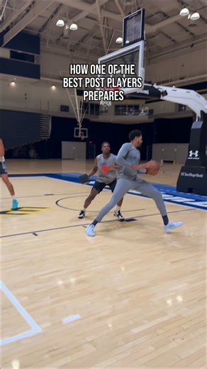 BASKETBALL BIOMECHANICS on Instagram: "Tobias is one of the league’s most efficient players in post-up points per possession, and this is a glimpse into how we stress that environment. We’re putting him on a small rim with blockers and live contact. When you can still create space, and control the ball through a tiny rim at that angle, a normal rim feels huge by contrast. This is how we calibrate for actual game environments: shrink the margin for error in training, then remove the constraint so