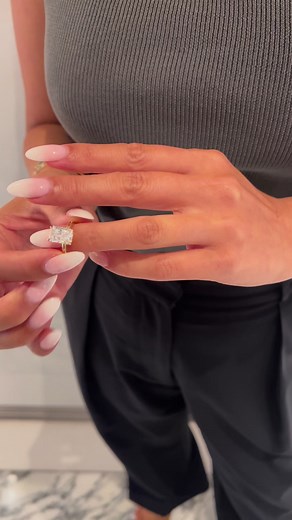 That moment when you try on your dream ring 😍. More than anything we believe in jewellery making you “feel”. When you put that ring on you need to feel like it’s you, and it’s an expression of your creativity. You need to feel proud every single time you put it on. 🥰. Featured here is a 3ct, colourless radiant cut diamond set on one of our bespoke solitaire 18k yellow gold settings. ☀️#ADB #engagementring #engagementrings #sydneyjeweller #proposals #diamondrings #radiantcut | Australian Diamon