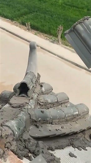 building a traditional grey tile roof structure with wet cement and many curved decorative pieces