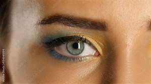 Girl opens her eyes and her pupils dilate and constrict. Close up