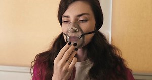 clip-3706035299-woman-putting-on-oxygen-mask-medical-health