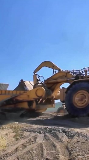 "Dozer Assisting Scraper: Powerful Teamwork on the Jobsite!" #HeavyMac...