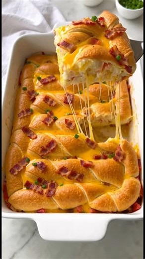 Bacon, Egg, and Cheese Crescent Roll Bake Ingredients Serves 12 1 lb bacon strips, crisp-cooked and chopped, or cooked ground pork breakfast sausage 1 medium red bell pepper, chopped (1 cup) 1 small onion, chopped (1/2 cup) 2 tbsp chopped fresh chives 1 8-oz pkg. refrigerated crescent rolls 3 cups shredded cheddar- Monterey Jack cheese 10 eggs, lightly beaten 3/4 cup milk 1 tbsp olive oil 1/2 tsp salt 1/4 tsp freshly ground black pepper Thinly sliced green onion (optional) #BaconEggCheese #Cresc