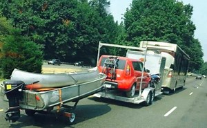 An RV, a car hauler, and a boat trailer all pull each other down the road: But is it legal?