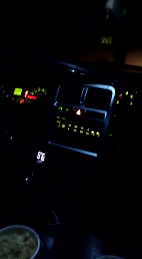 Nighttime Vehicle Dashboard: Speedometer and Gauges in Focus