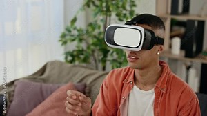 Close view of the multi ethnic man use vr headset glasses at home for studying purposes. African-American man with pleasure uses head-mounted display. Virtual reality and modern gadget device