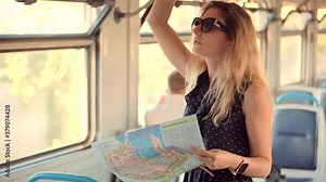 Woman Tourist Looking On City Paper Map And Exploring City Route.Female Traveler Waiting Train And Looking Town Plan On Navigation Map For Journey.Active Lifestyle On Vacation Travel Tourism Adventure
