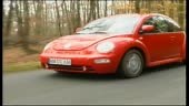 Volkswagen Beetle driving on roads, as featured in the Men and Motors...