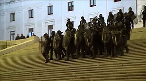 Portuguese demonstrators throw projectiles during general strike