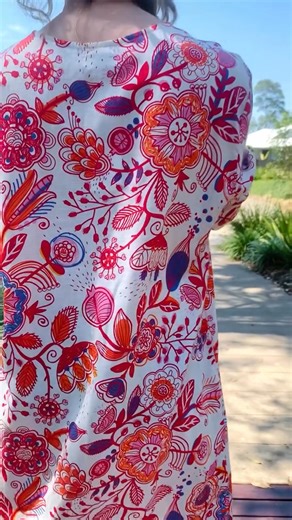 This sophisticated Red Floral Linen Blend Tunic showcases vibrant...