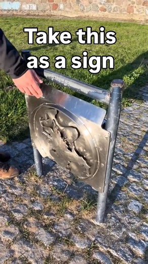Geocaching on Instagram: "💚 Geocache of the Week 💚 We’re kicking off our 2026 Geocache of the Week series with a twist, quite literally, with Danke Prora 2013 (GC47NWY)! What is your geocaching goal for 2026? Video by gc.an004. Video: A geocacher approaches a metal sign in a coastal park. On the front of the sign is a metal emblem cut to resemble the outline of an island. The geocacher grabs the edge of the emblem and twists it counterclockwise, which opens a metal door on the other side of th