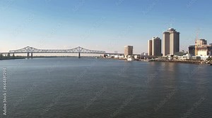 A beautiful view of the Mississippi River, the Crescent City Connection bridge, and New Orleans