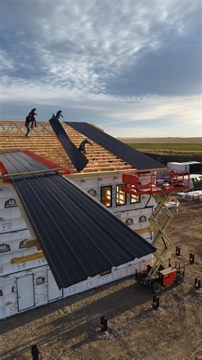 Unwrapping and installing these nice 48 foot long @MetalWholesale roof sheets on the new building!