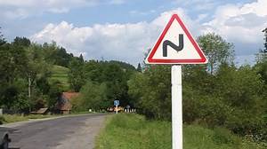 Traffic sign by road. Road sign - hairpin bend