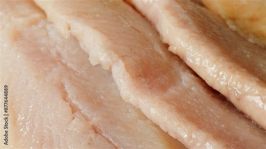 Raw herring fish slices a black plate close-up macro. Marinated herring fillet in oil and spices for appetizer. Raw seafood products