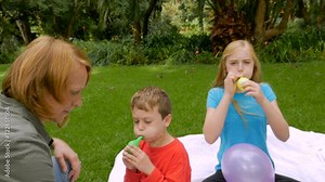 A mom comes to help her youngest son blow up balloons - slowmo steadicam