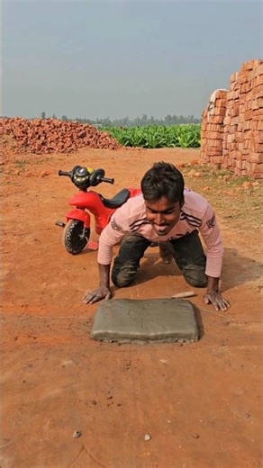 The boy cut the cake in the middle of the road.