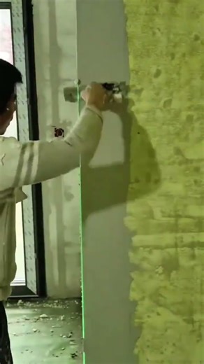 Applying precision plastering to straighten wall corners using laser alignment guide