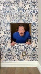 Secret door behind moving bookcase scares her!