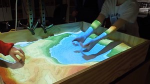 This is called the Augmented Reality Sandbox... It turns science into play time for kids and adults! UC Davis has developed 3D visualization applications for teaching earth science; how to read a topographical map, the meaning of contour lines, watersheds, catchment areas, levees, etc. Now users can create topography models by simply shaping real sand! | The Owner-Builder Network