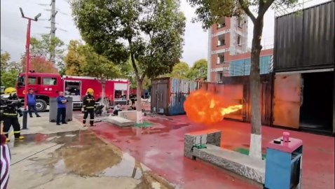Chinese firefighters use water shield to combat blaze