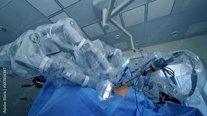 Robotic arms on patient's body. Modern medical machine with minimally invasive involvement in hospital. Futuristic surgery with robotic equipment.