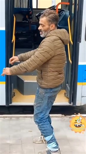 Man in Brown Puffer Jacket Experiences Bus Step Mishap