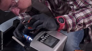 Trying to fix coffee machine. Service and repair of coffee maker. Adult handyman repairing coffee machine by screwdriver at home. Male mend percolator in goggles and black rubber gloves