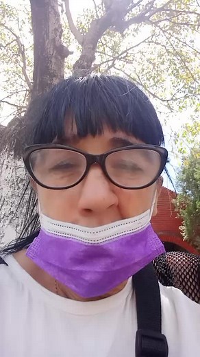 Adjusting Face Mask Outdoors: A Casual Moment