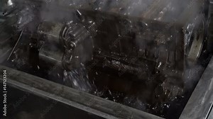 Washing of the cylinder block of the diesel engine in the bathroom with a special boiling solution before repairing.