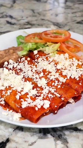 Authentic Red Mexican Enchiladas en Salsa Roja. I'm going to share with you a very easy recipe of how I make Enchiladas Rojas 😋 I hope you enjoy this recipe. Please comment down below what recipe you will like to see next. Also, check out our YouTube Channel for the full video and for more delicious recipes. Link in Bio. ENCHILADAS ROJAS INGREDIENTS: ► 7 California or guajillo chiles ► 2 chile ancho ► 4 chile árbol ► 1 Roma Tomato ► 2 garlic cloves ► 1/4 white onion ► Corn tortillas ► Queso fre