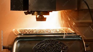A hot and noisy stamping press creates the intricate designs on a new toaster.